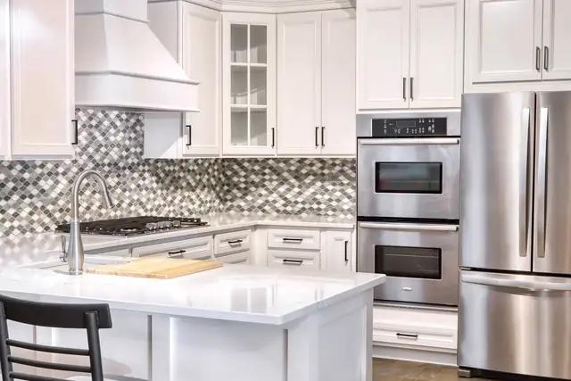 Elkhart and Goshen area white kitchen with mosaic tile backsplash, white island and double wall ovens