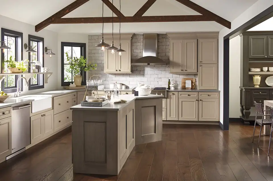 Kitchen remodeling in Elkhart: open kitchen with greige painted cabinets, a matching island, white subway tile and exposed wood ceiling beams